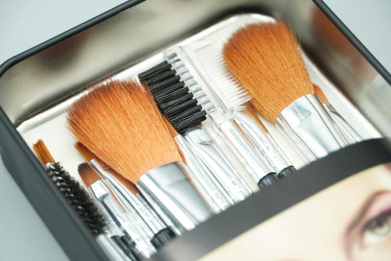 A close-up view of a set of professional makeup brushes inside a sleek box, ideal for beauty routines.