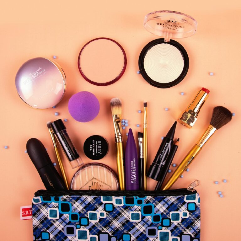 A vibrant assortment of makeup tools and products stylishly arranged on a peach background.